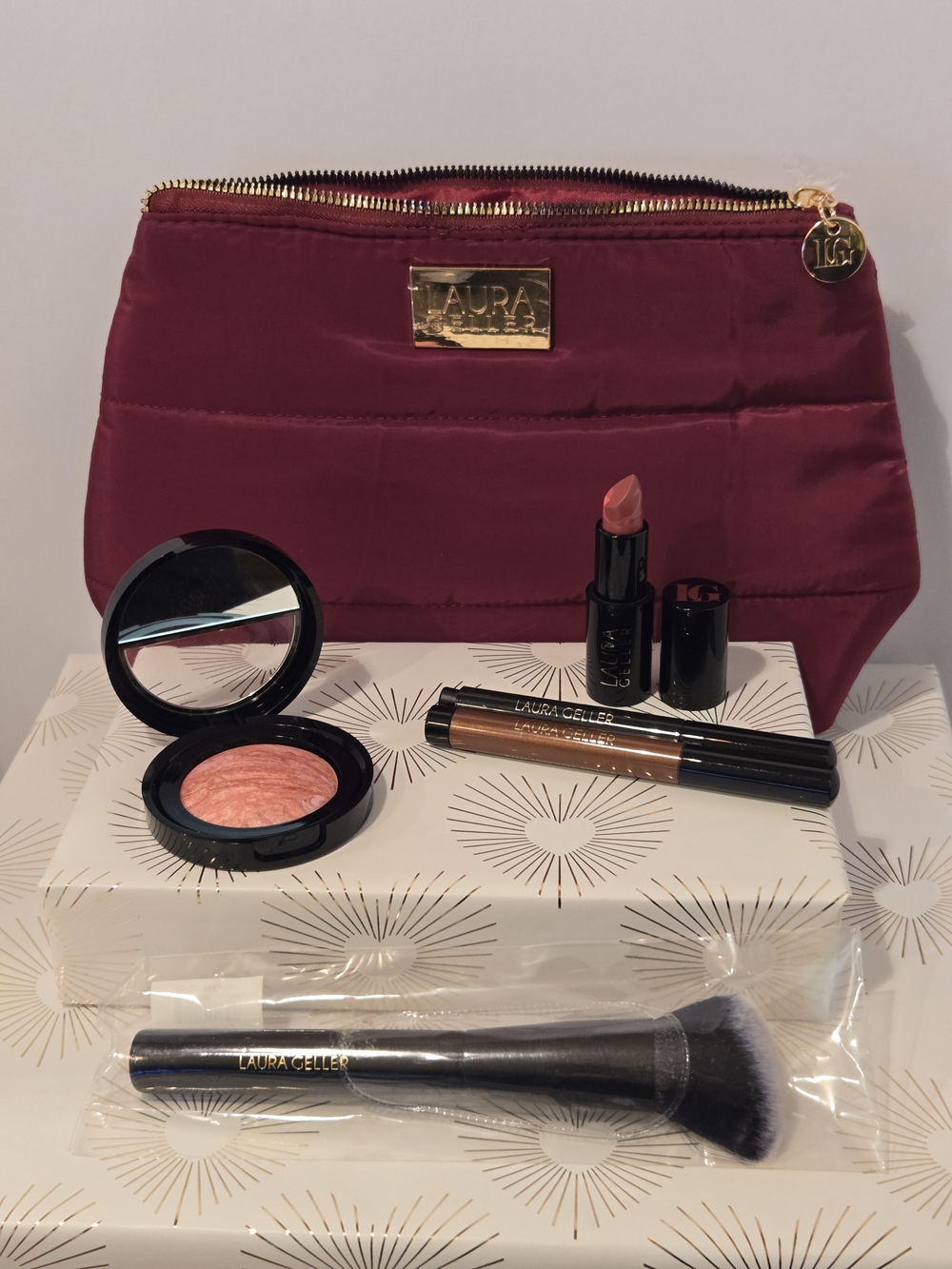 Laura Geller Makeup Bundle With Wine Quilted Cosmetic Pouch.
